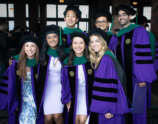 Students pose for a group photo at the 2024 MD commencement ceremony