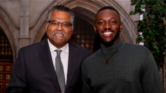 Two men smiling, standing next to each other