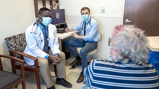 Students meet with a patient at their Education-Centered Medical Home