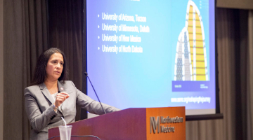 A photo of a keynote speaker presenting at a podium