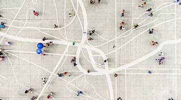 Overhead view of people walking down pathways