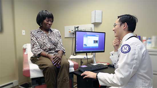 A Family Medicine resident speaks with a patient