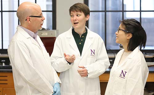 Stephen Adam and two trainees in lab coats