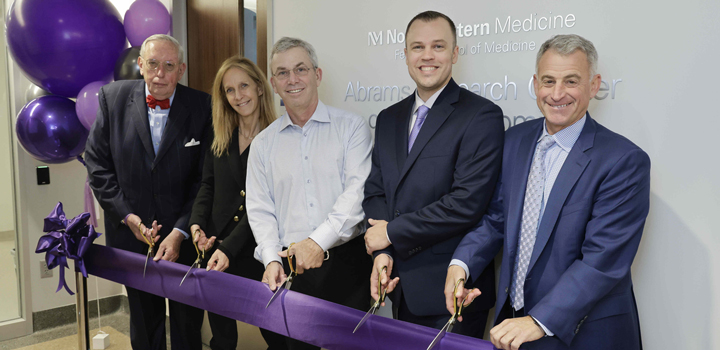 Five people cutting a ribbon in front of the new neurogenomics center