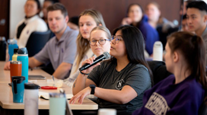 a student with a microphone speaking