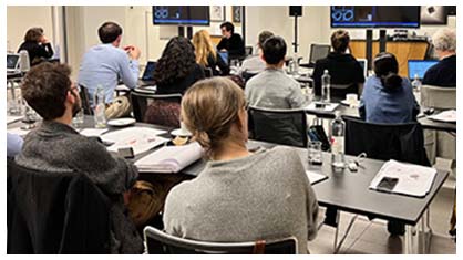 Image of members in audience listening to a talk